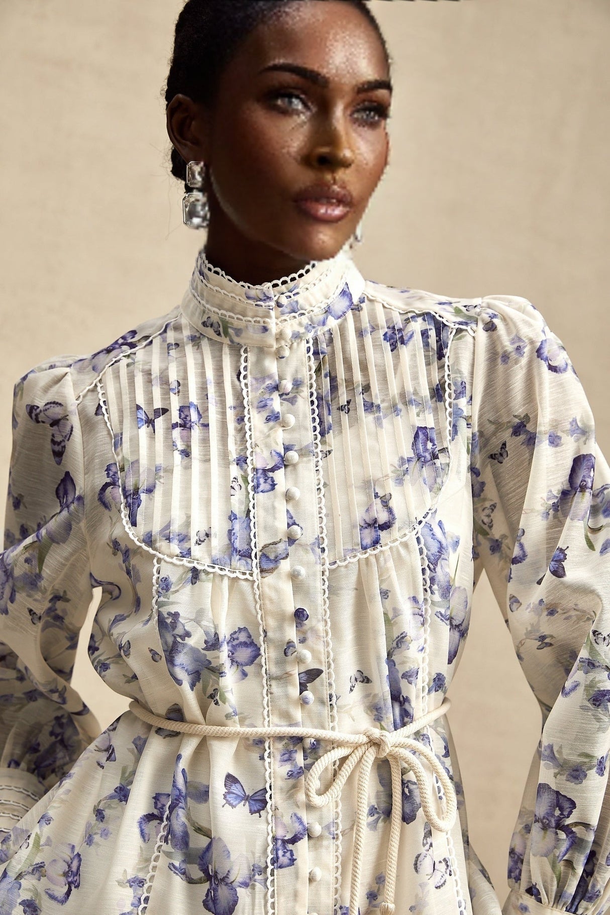 A short floral print chiffon dress with a flared skirt and mini length featuring a colorful floral pattern on a light background
