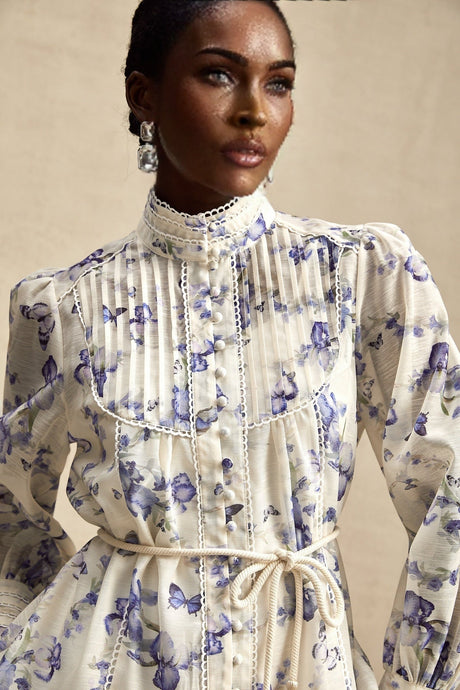 A short floral print chiffon dress with a flared skirt and mini length featuring a colorful floral pattern on a light background