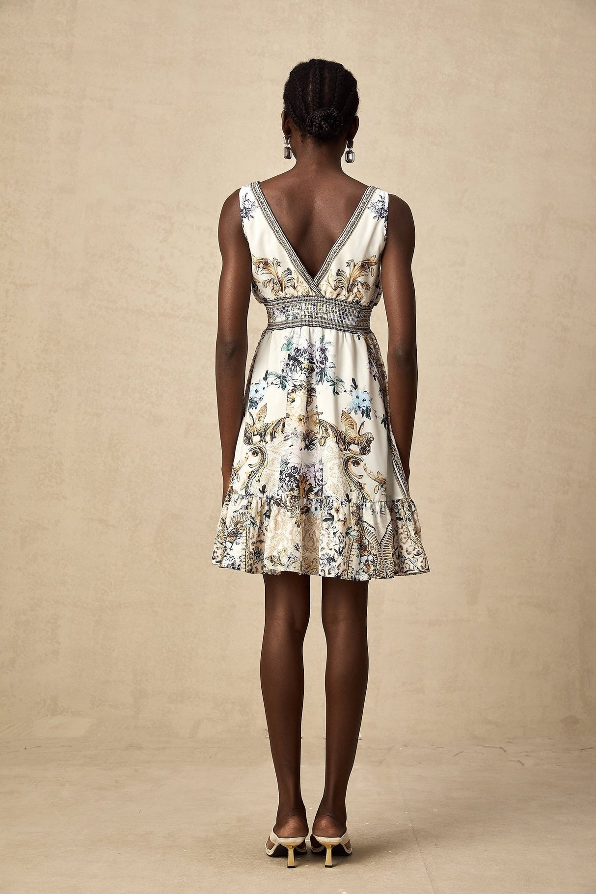 A short floral print dress with a vneck neckline and a mini length in a vibrant pattern