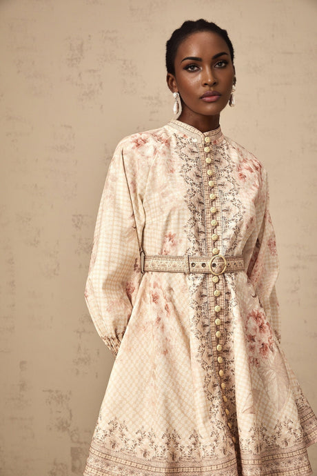 A short floral print mini dress with a belt accent cinched at the waist featuring a vibrant pattern and feminine silhouette