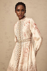 A short floral print mini dress with a belt at the waist featuring a colorful pattern on a light background