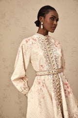 A short floral print mini dress with a belt cinching the waist featuring a colorful pattern on a light background