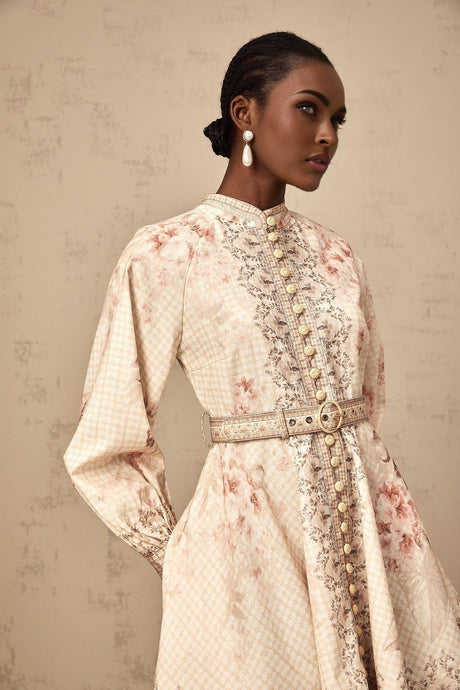 A short floral print mini dress with a belt cinching the waist featuring a colorful pattern on a light background