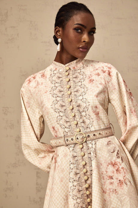 A short floral print mini dress with a belt cinching the waist featuring a colorful pattern on a light background