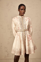 A short floral print mini dress with a belt cinching the waist featuring a colorful pattern on a light background
