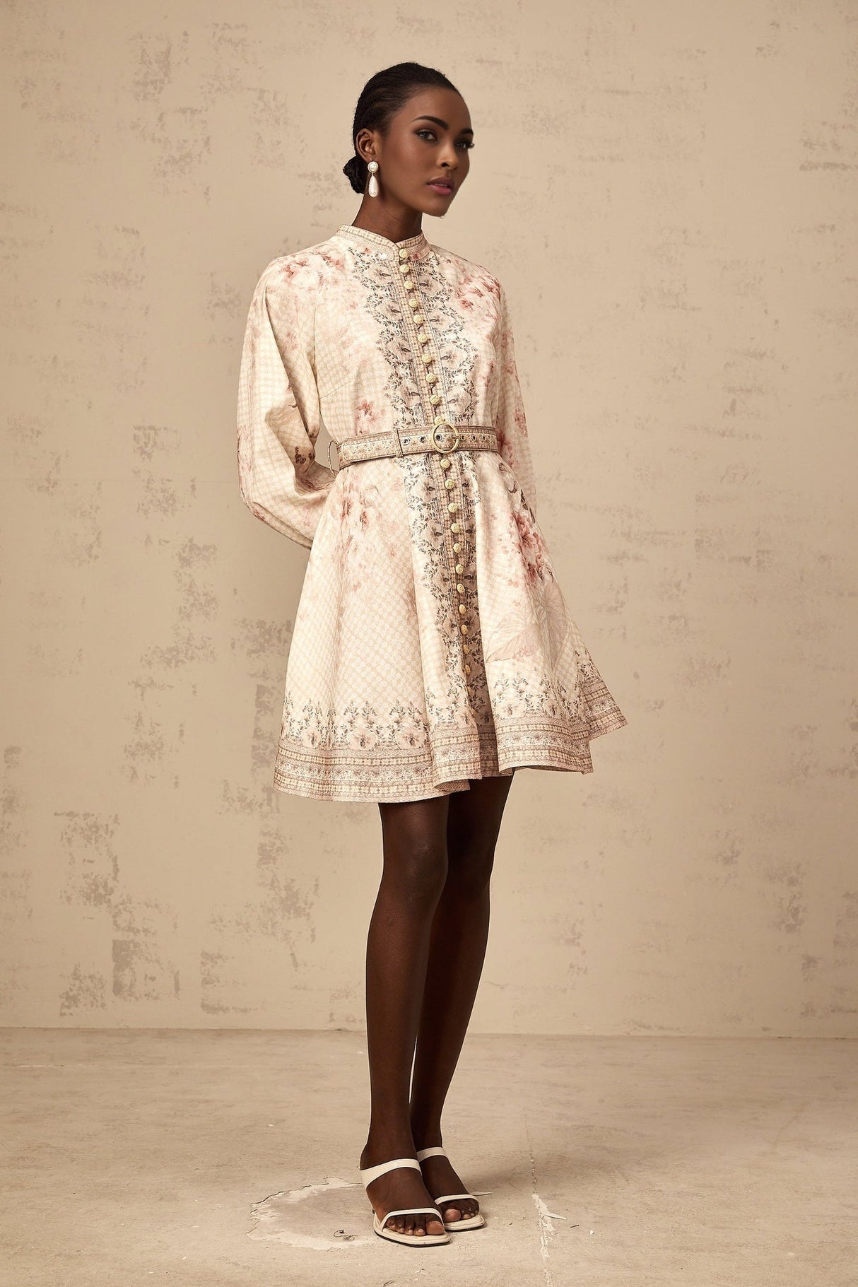 A short floral print mini dress with a belted waist featuring the Quincia design