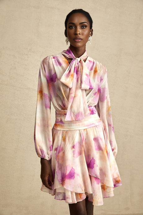 A short floral print mini dress with a V neckline and the brand name Maelys