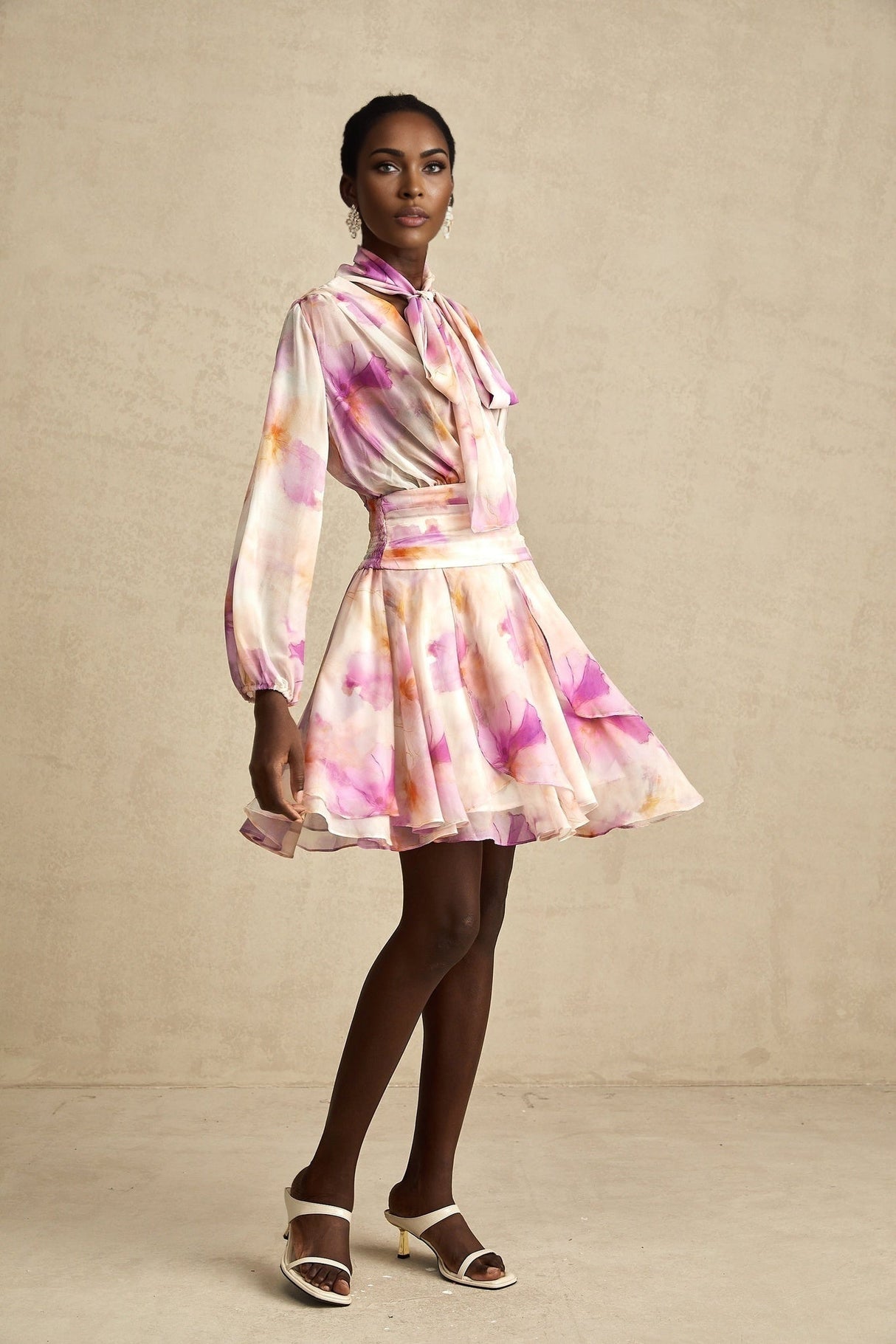 A short floral print mini dress with a V neckline in the Maelys style
