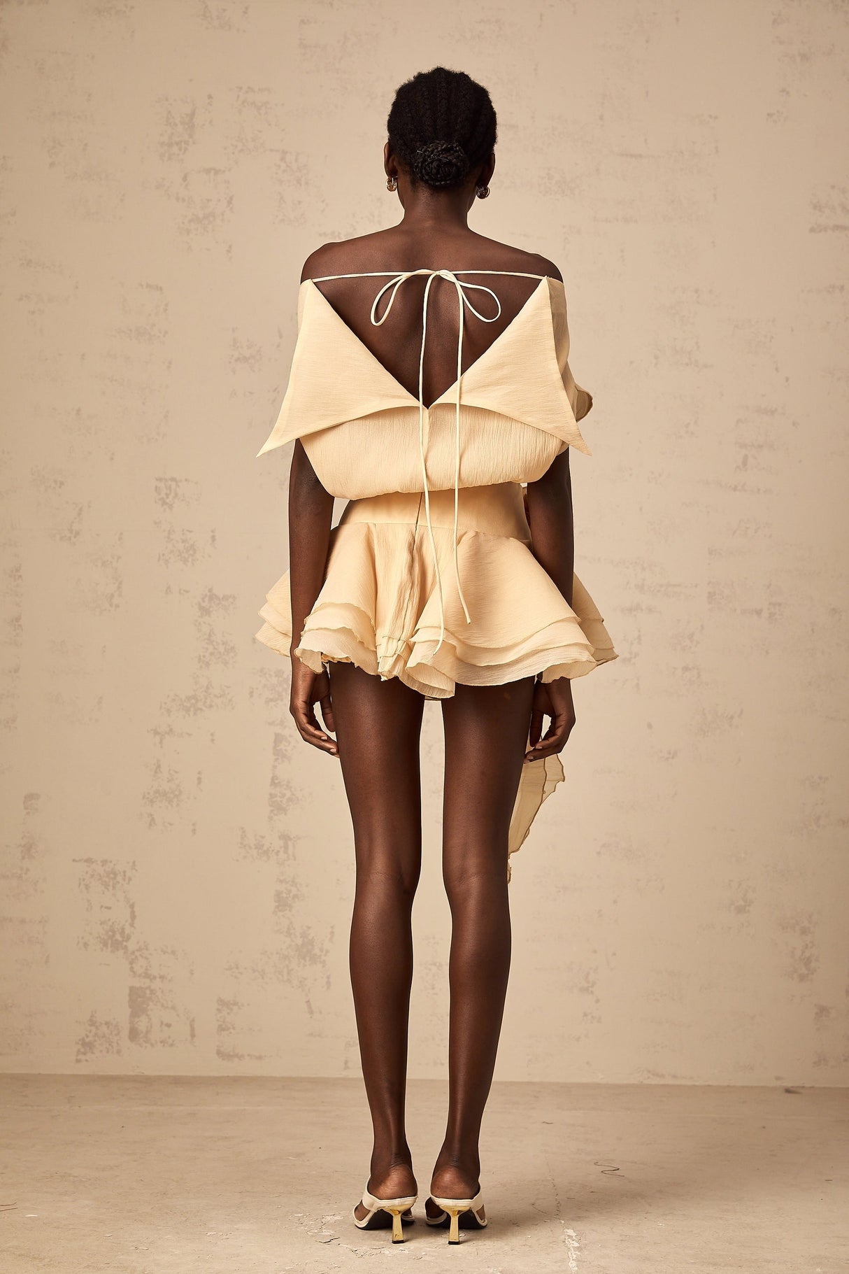 A short flounced mini dress with floral appliques featuring a light and feminine design