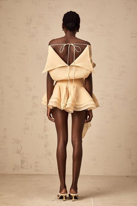 A short flounced mini dress with floral appliques featuring a light and feminine design