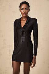 A short gold mini dress with a plunging V neckline adorned with studs and embellishments