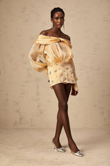 A short gold mini dress with crystal embellishments and panel detailing
