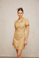 A short gold mini dress with sequin embellishments and a tweed texture shimmering in the light