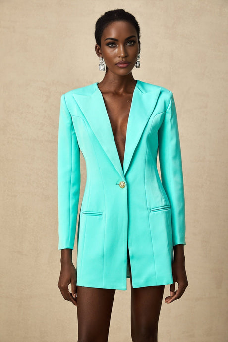 A short green blazer dress with a cinched waist and mini length featuring a tailored collar and lapels