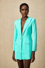 A short green blazer dress with a cinched waist and mini length