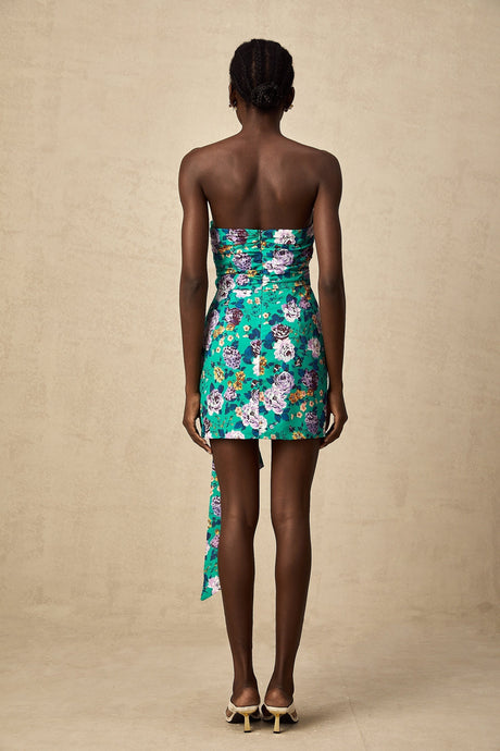 A short green dress with a floral pattern and ruched detailing
