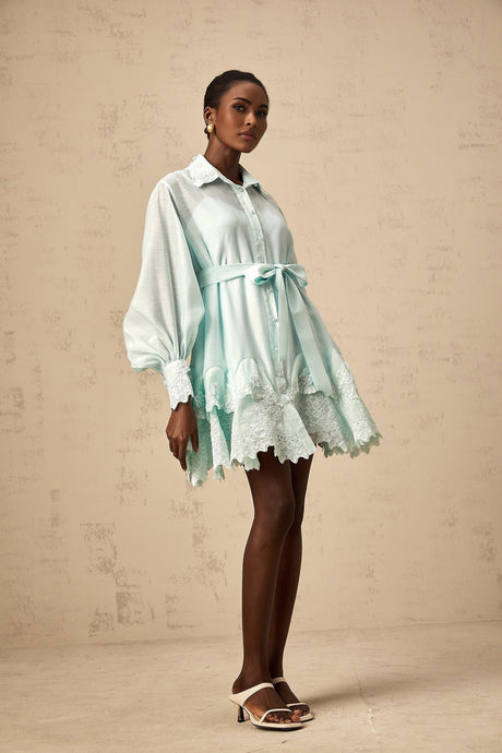 A short green dress with lace panels and a shirtstyle collar featuring a mini length and sleeves