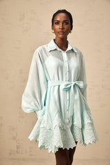 A short green mini dress with lace panel details and a shirt style collar