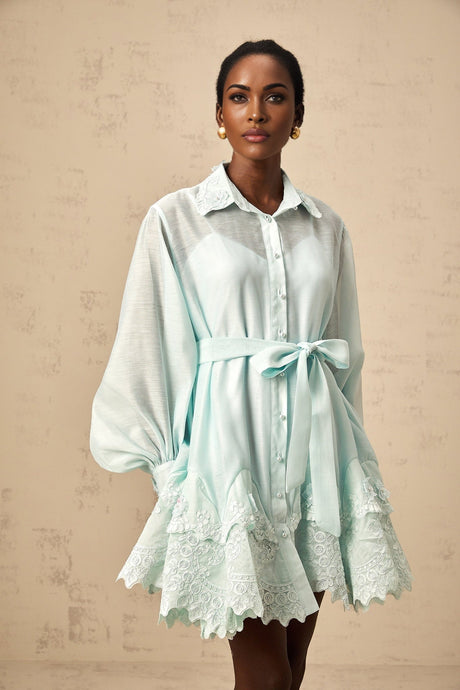 A short green mini dress with lace panel details and a shirt style collar