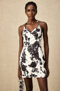 A short halterneck mini dress with a floral print pattern featuring a design called Gabrielle