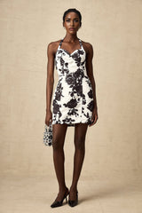 A short halterneck mini dress with a floral print pattern named Gabrielle