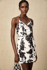 A short halterneck mini dress with a floral print pattern named Gabrielle