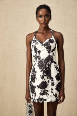 A short halterneck mini dress with a floral print pattern named Gabrielle
