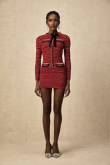 A short knit mini dress with a bow detail named Faustine