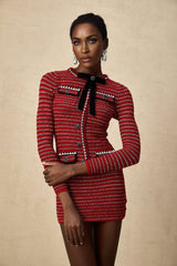 A short knit mini dress with a prominent bow detail named Faustine