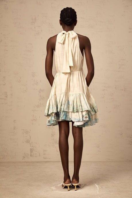 A short layered mini dress with a mixed pattern print featuring different floral and geometric designs in multiple colors
