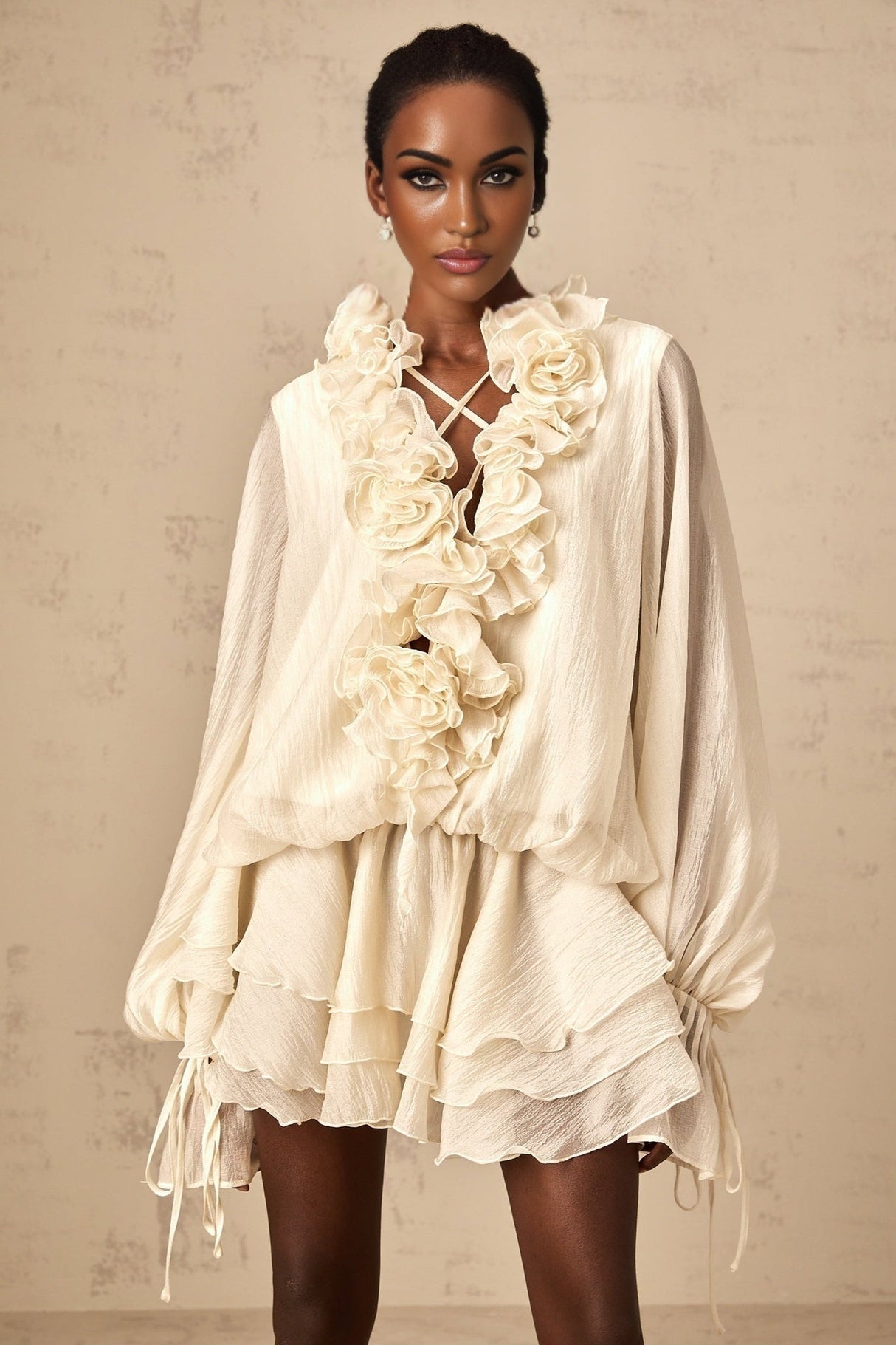 A short neutral colored mini dress with tiered layers and floral applique details named Zephyrine