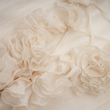 A short neutral colored mini dress with tiered skirt and floral applique details named Zephyrine