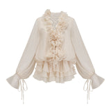 A short neutral colored tiered mini dress with floral applique details named Zephyrine
