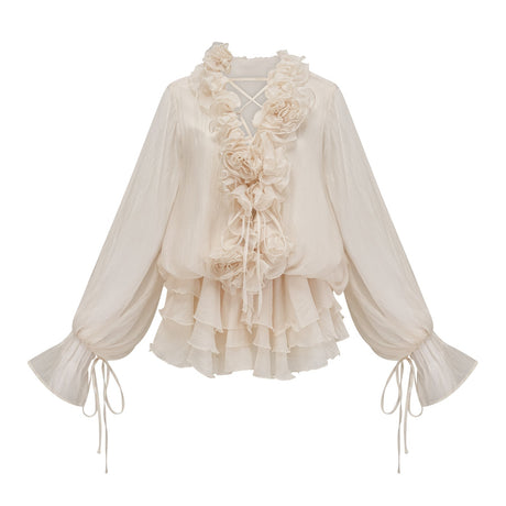 A short neutral colored tiered mini dress with floral applique details named Zephyrine
