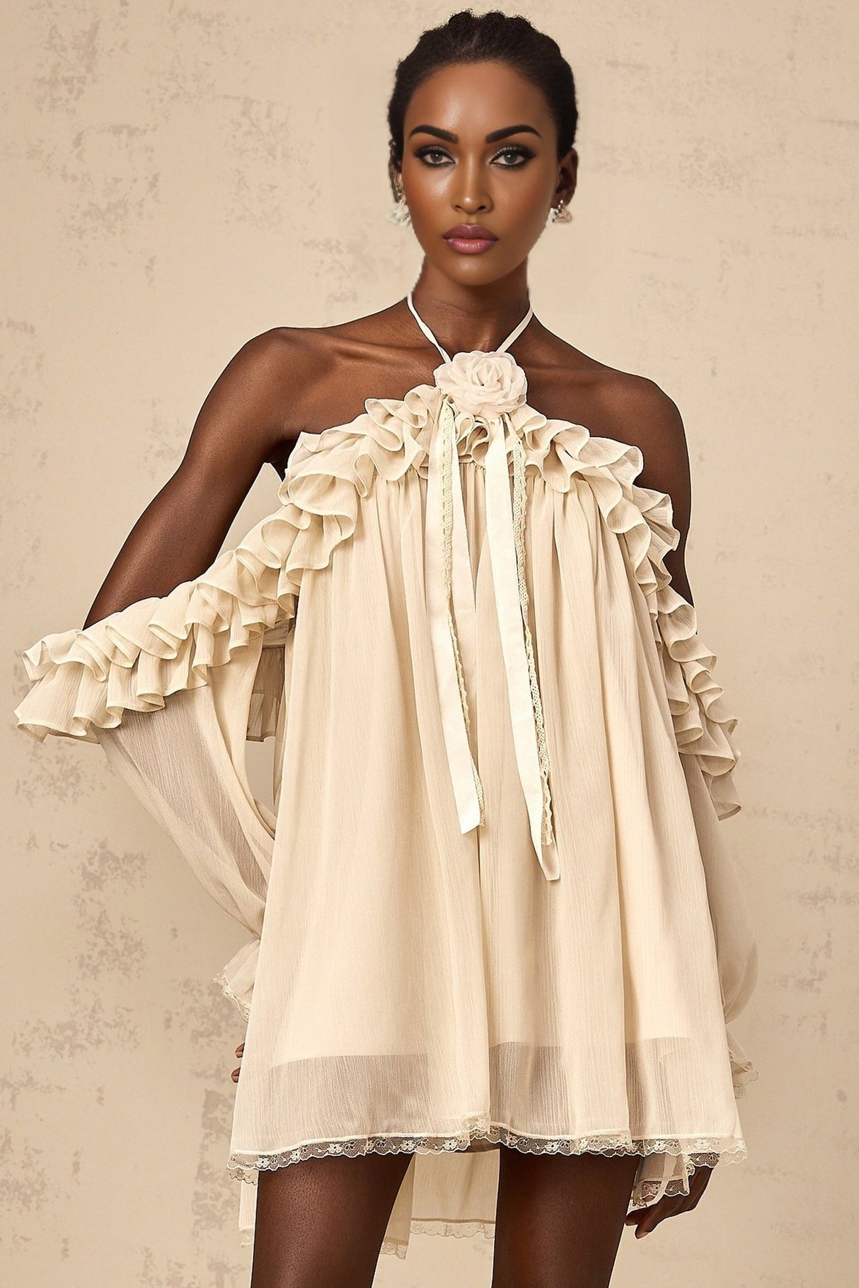 A short neutraltoned mini dress with ruffled details and floral appliques adorning the fabric