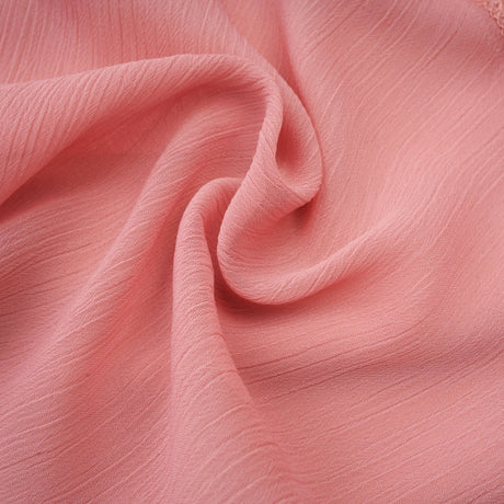 A short pink dress with a halter neckline and tiered skirt in a briar rose shade The mini dress features multiple ruffled layers creating a flirty and feminine silhouette