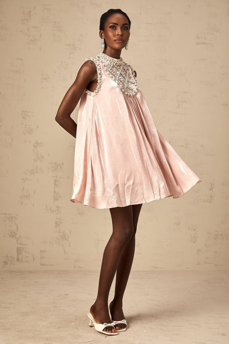 A short pink dress with pleated skirt and embellished details named Helena