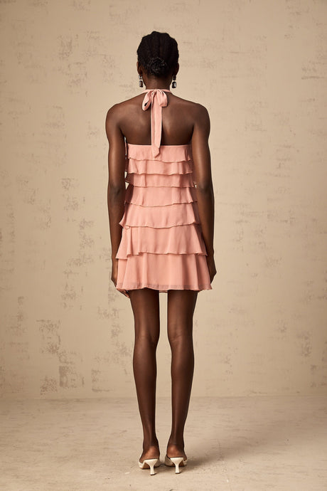 A short pink halter neck dress with multiple tiers creating a flowy silhouette The dress has a mini length and a vibrant briar pink color
