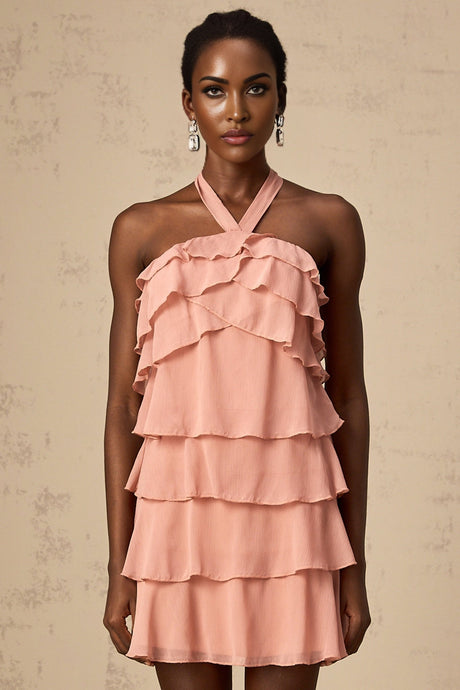A short pink halterneck dress with tiered ruffles and a mini length skirt
