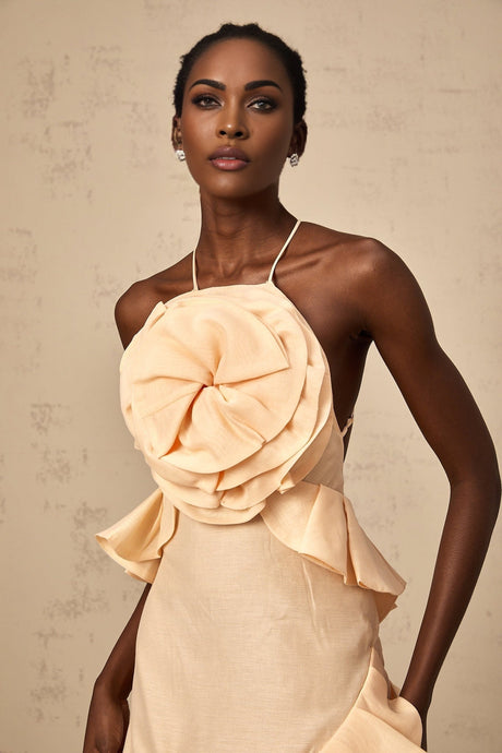 A short pink mini dress with 3D petallike ruffles adorning the fabric creating a textured floral effect throughout the garment