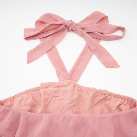 A short pink mini dress with a halter neckline and tiered skirt design in a briar rose shade