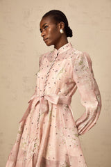 A short pink mini dress with floral print and embellishments featuring a narcissus flower design