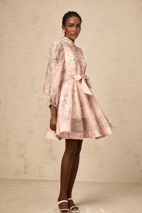 A short pink mini dress with floral print pattern and embellished details featuring a design inspired by narcissus flowers