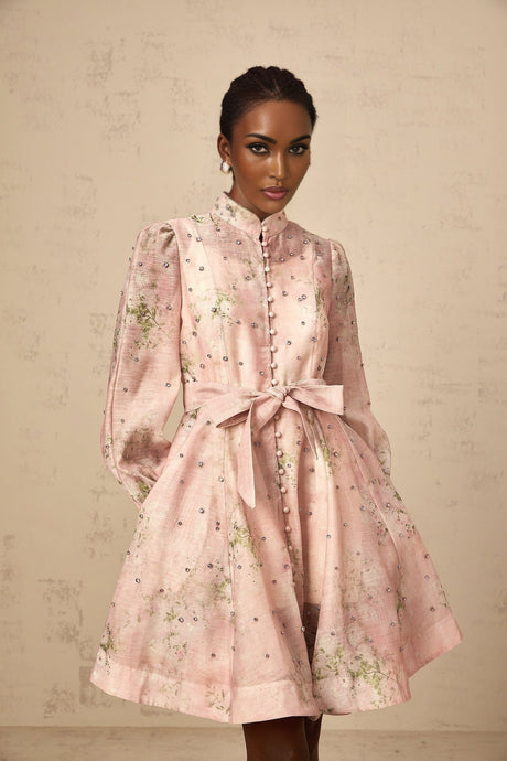 A short pink mini dress with floral print pattern and embellished details featuring a narcisse design