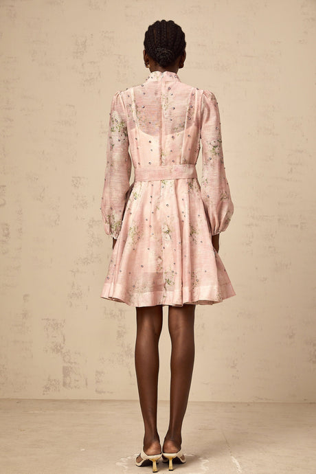 A short pink mini dress with floral print pattern and embellished details