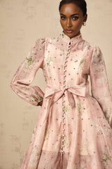 A short pink mini dress with floral print pattern and embellished details