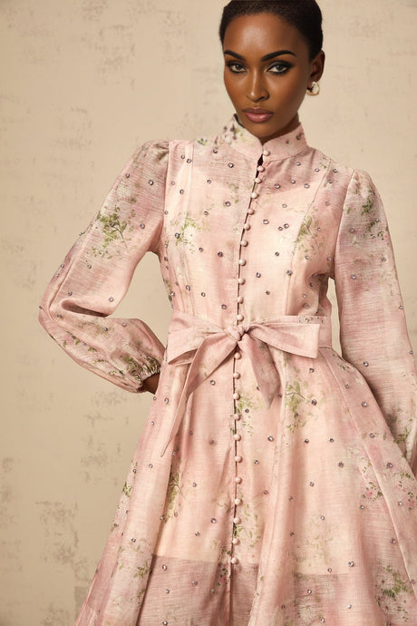 A short pink mini dress with floral print pattern and embellished details
