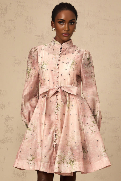 A short pink mini dress with floral print pattern and embellished details