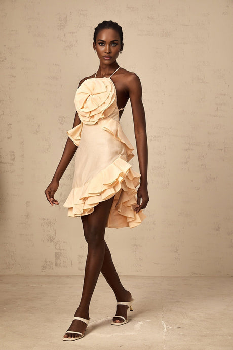A short pink mini dress with threedimensional petallike ruffles covering the entire garment creating a floral textured appearance
