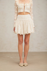 A short pleated mini skirt with sequin embellishments called Tiphaine